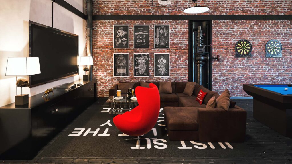 Industrial-style entertainment room with exposed brick walls, sectional sofa, red accent chair, pool table, and dart boards