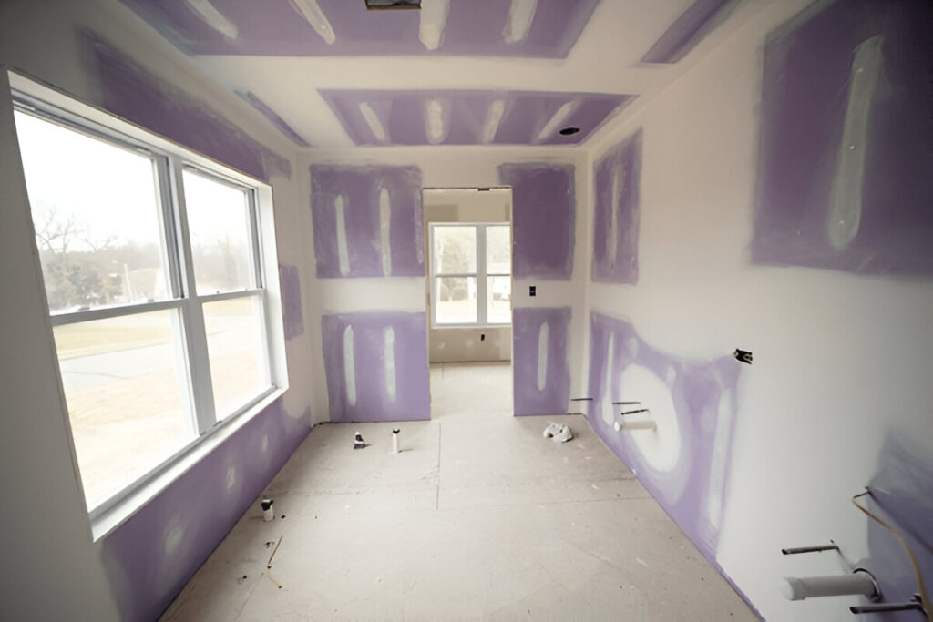 Kitchen under construction with drywall installation in progress