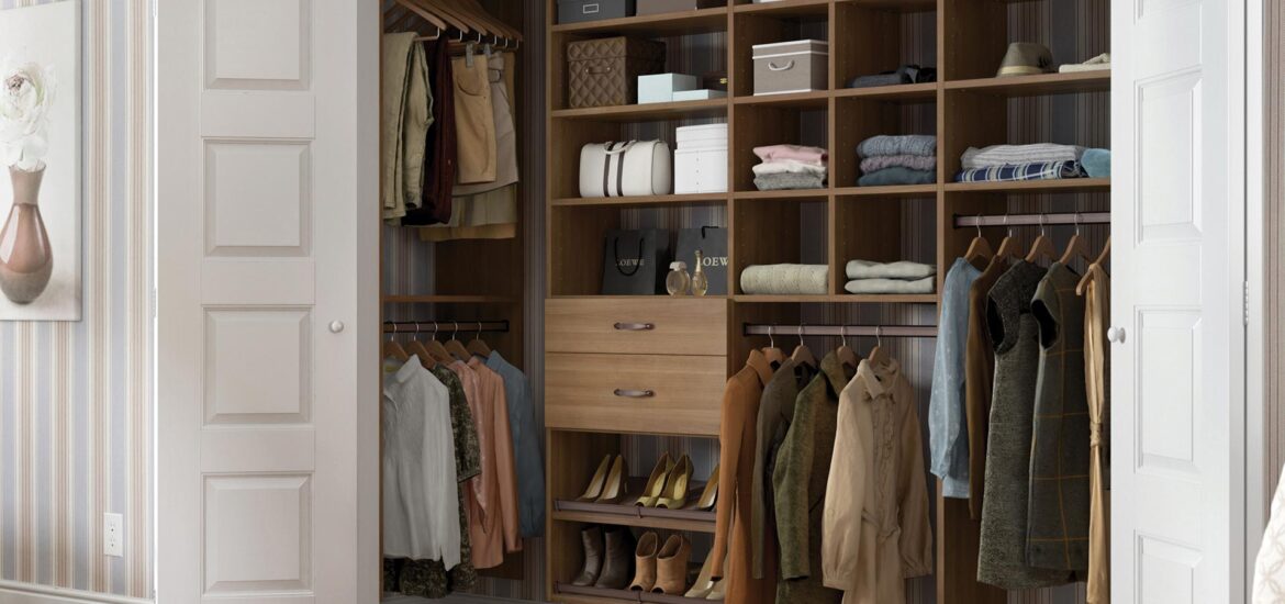 A well-organized reach-in closet with custom wood shelving, built-in drawers, hanging space, and storage compartments for clothing, shoes, and accessories.