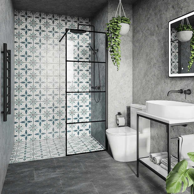 Modern small bathroom with patterned tile shower wall, black-framed glass shower, and concrete walls