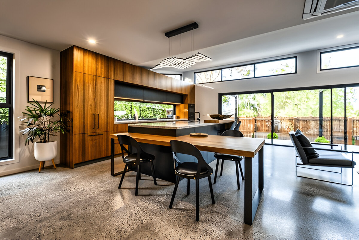 Modern kitchen with wood cabinets and large windows