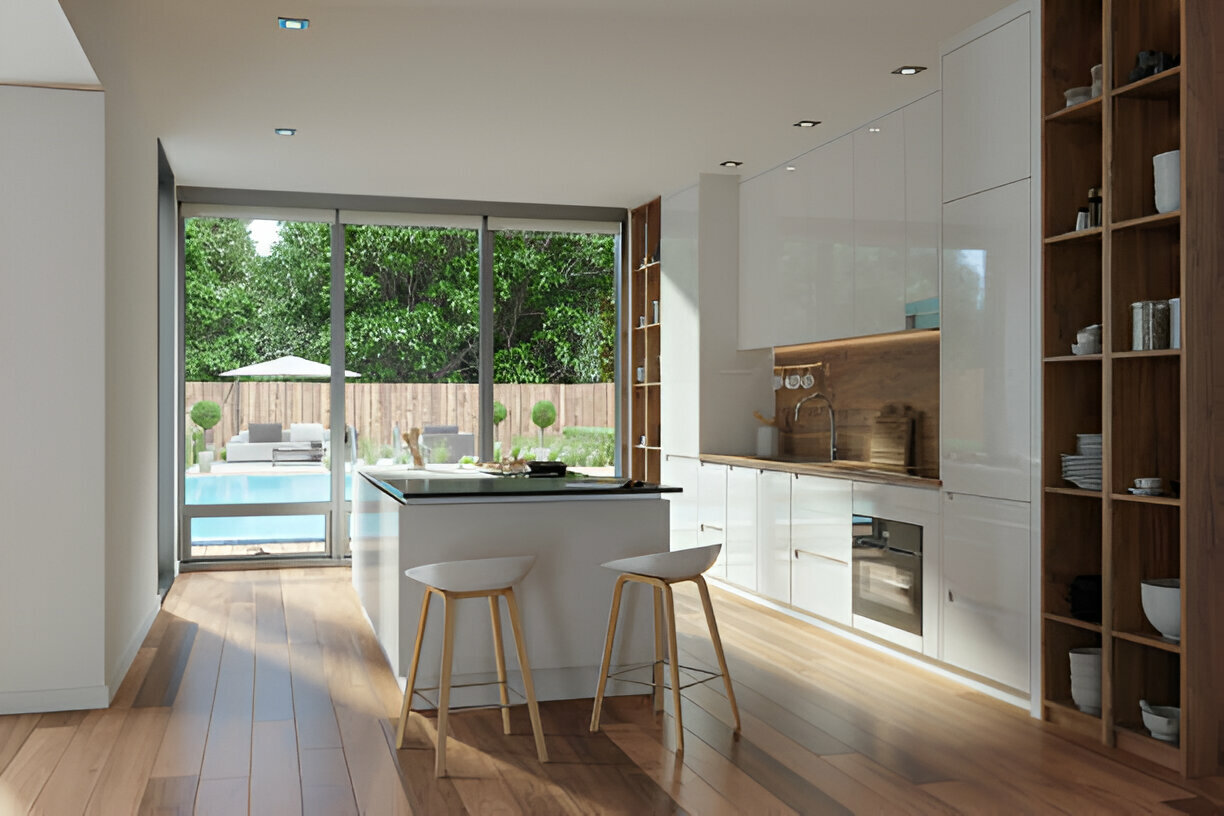 Modern kitchen with white cabinetry and island opening to poolside view