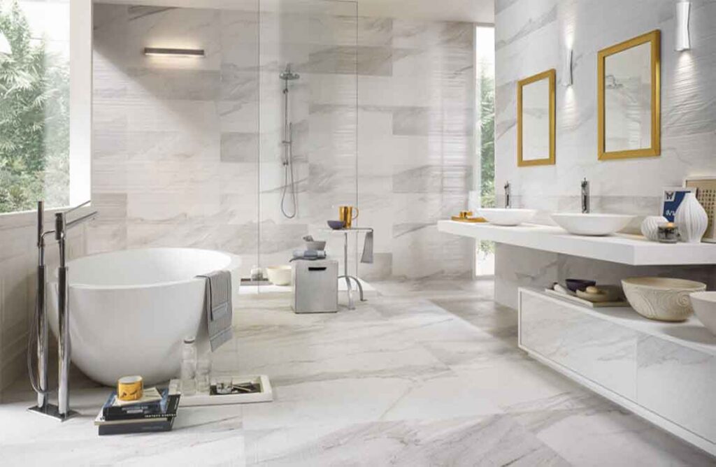 Smart Remodeling Solutions for Small Bathrooms 8 Bright modern bathroom featuring a freestanding oval tub, dual vessel sinks, walk-in shower, and large marble-look tiles