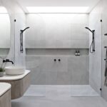 Modern Scandinavian bathroom featuring double walk-in showers, floating vanities, round mirrors, and matte black fixtures