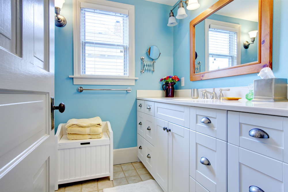 A spacious walk-in closet with built-in shelving, hanging rods, and drawers, organized neatly with clothing, shoes, and accessories. A comfortable chair and a soft rug add a touch of elegance.