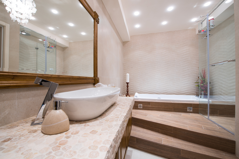The image shows a spacious and well-lit bathroom with a large shower, elegant fixtures, and a minimalist aesthetic.