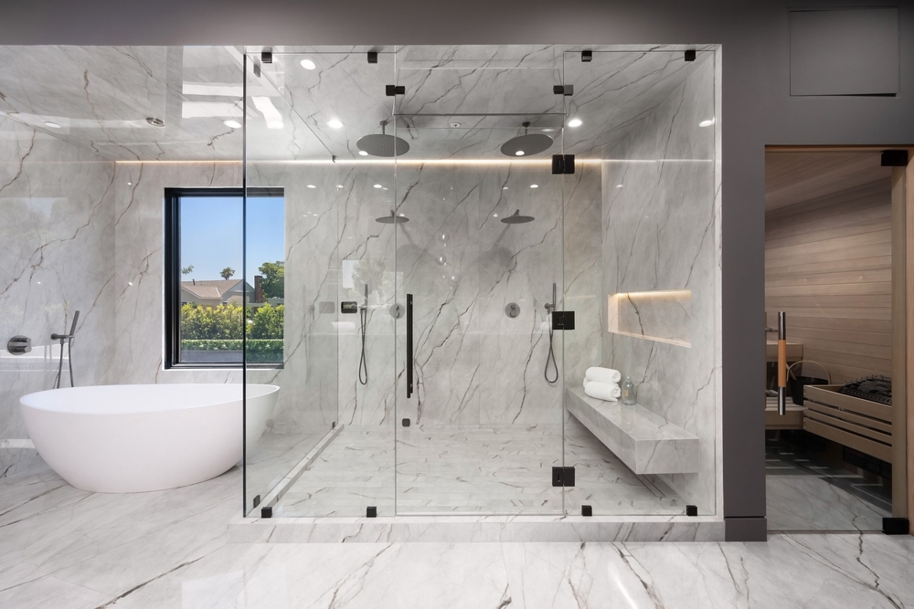  A well-lit, spacious walk-in closet with neutral decor, organized clothing, and a cozy seating area.