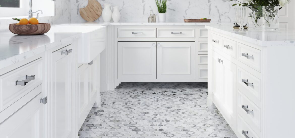 Bright white kitchen with marble countertops, hexagon-pattern marble tile flooring, and classic cabinetry.