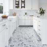 Bright white kitchen with marble countertops, hexagon-pattern marble tile flooring, and classic cabinetry.