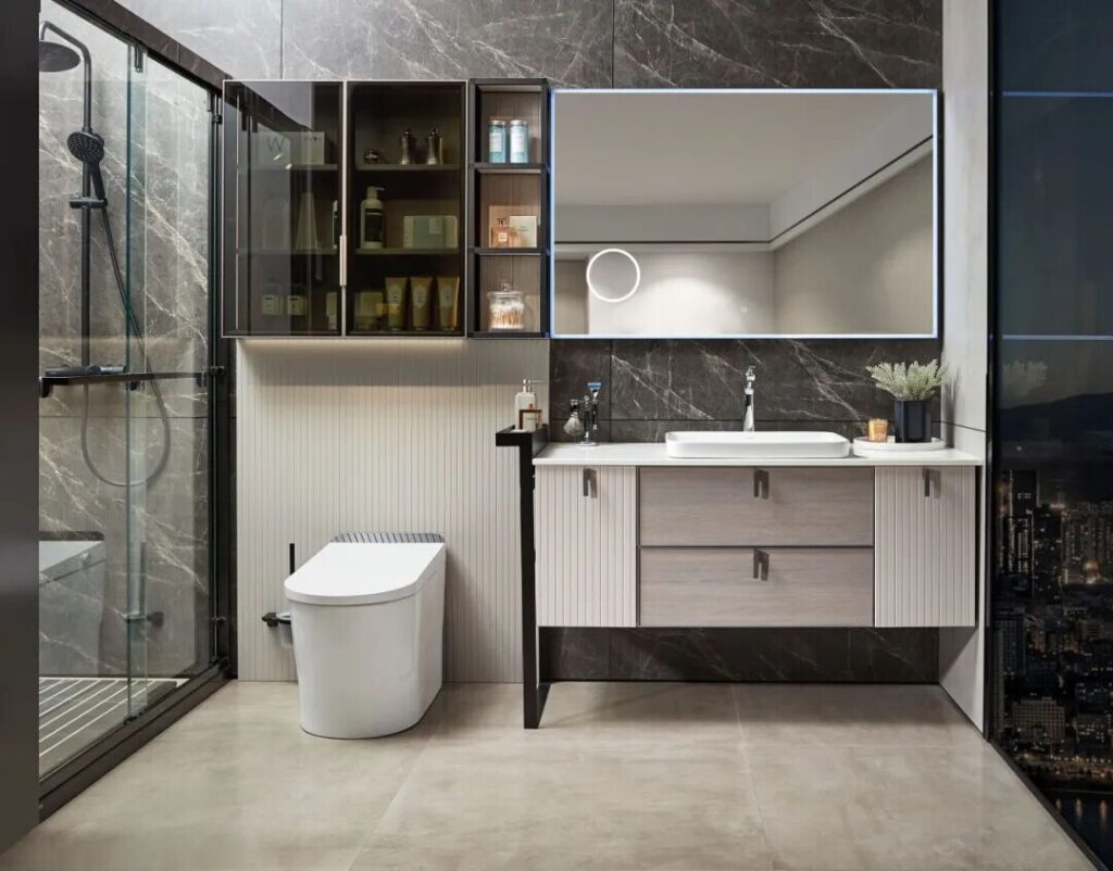 Contemporary bathroom with a smart toilet, floating vanity, LED mirror, and glass-enclosed shower against dark marble walls.