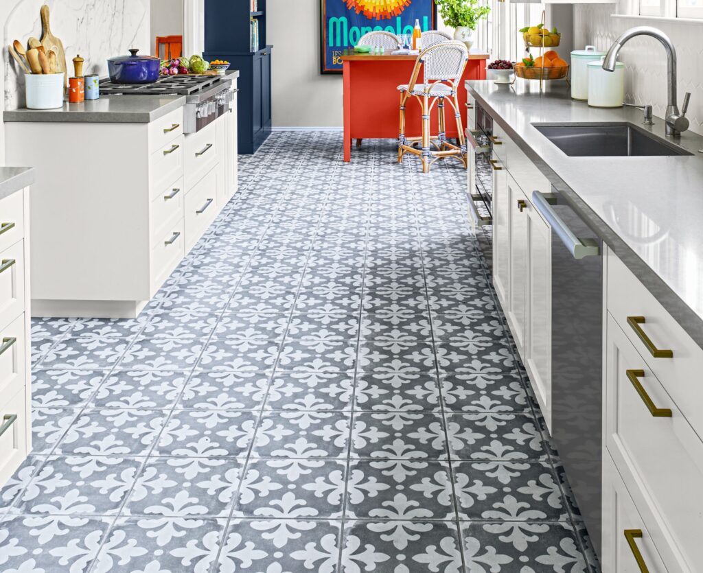 Top Kitchen Flooring Trends for 2025 12 Kitchen with gray and white patterned cement tiles, white cabinets, and a red island.