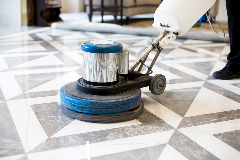 Top Kitchen Flooring Trends for 2025 14 Close-up of a floor buffer polishing a marble tile floor with a geometric patte