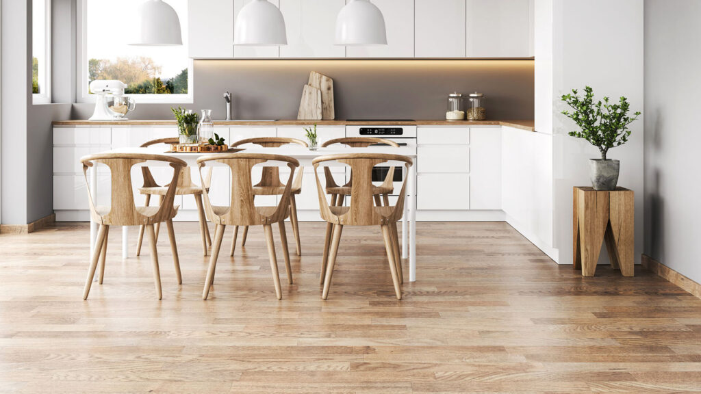 Top Kitchen Flooring Trends for 2025 13 Minimalist white kitchen with natural light wood flooring and Scandinavian-style dining set.