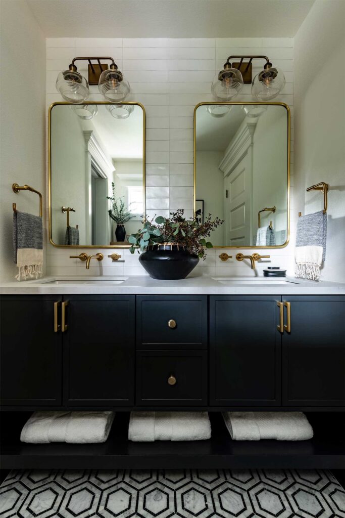 Custom Cabinetry Trends for Bathrooms to Watch in 2025 11 Elegant bathroom with a glass-enclosed shower, wood cabinetry, large backlit mirror, and sleek double sinks