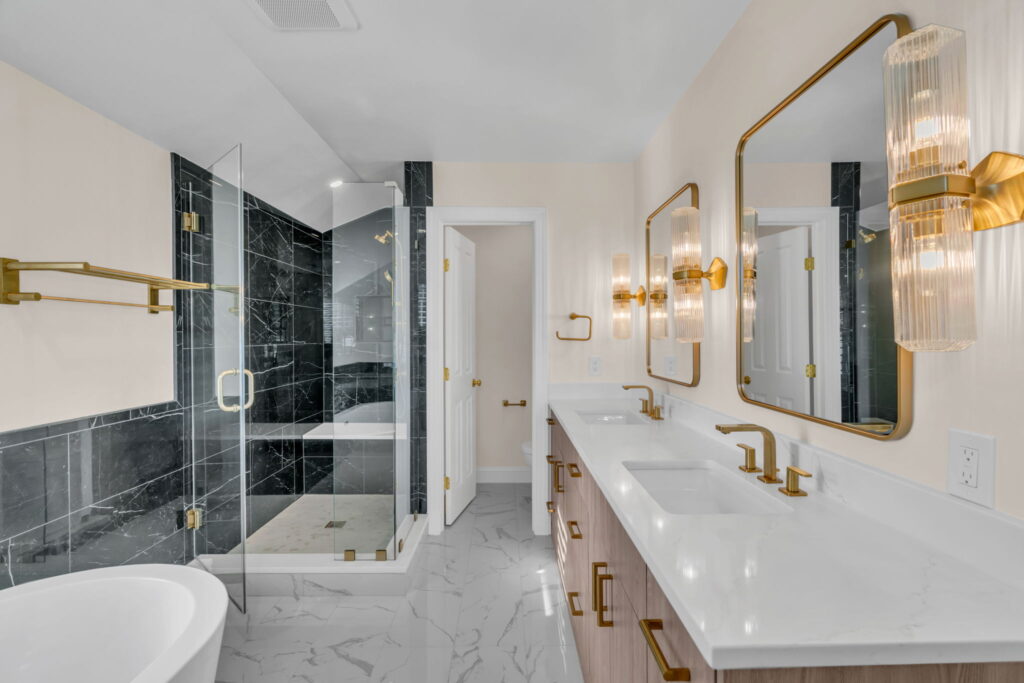 Luxurious modern bathroom with gold fixtures and black marble shower