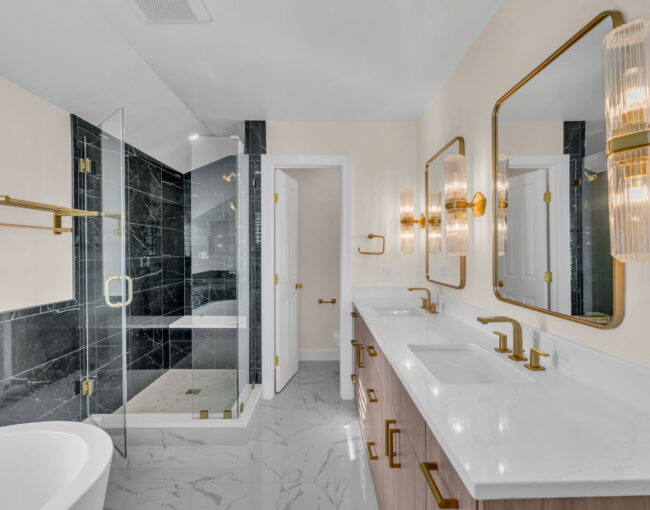Luxurious modern bathroom with gold fixtures and black marble shower