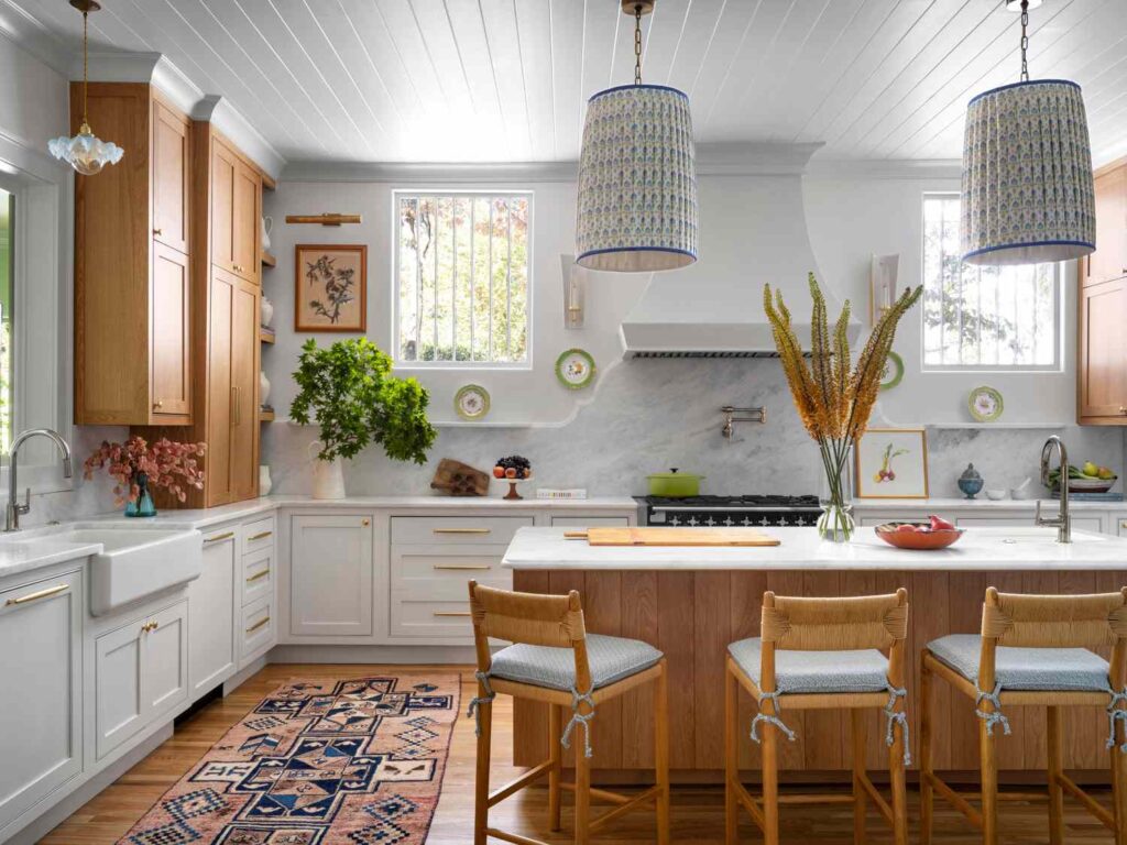  Warm and inviting kitchen with mixed wood and white cabinetry and large island