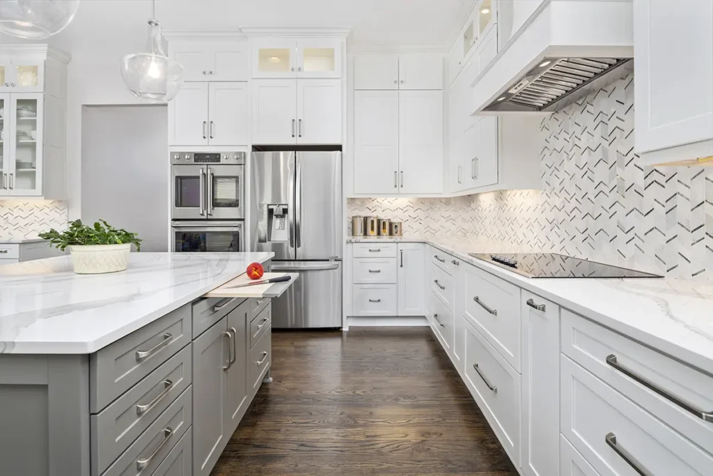  Sleek kitchen with white cabinets, gray island, and patterned tile backsplash