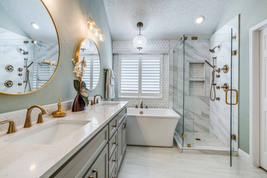 Elegant bathroom with round mirrors, freestanding tub, and marble shower