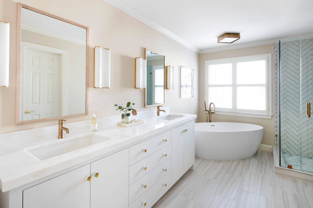 Bright and airy bathroom with freestanding tub and herringbone tile shower