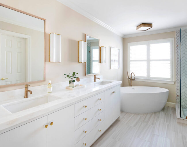 Bright and airy bathroom with freestanding tub and herringbone tile shower