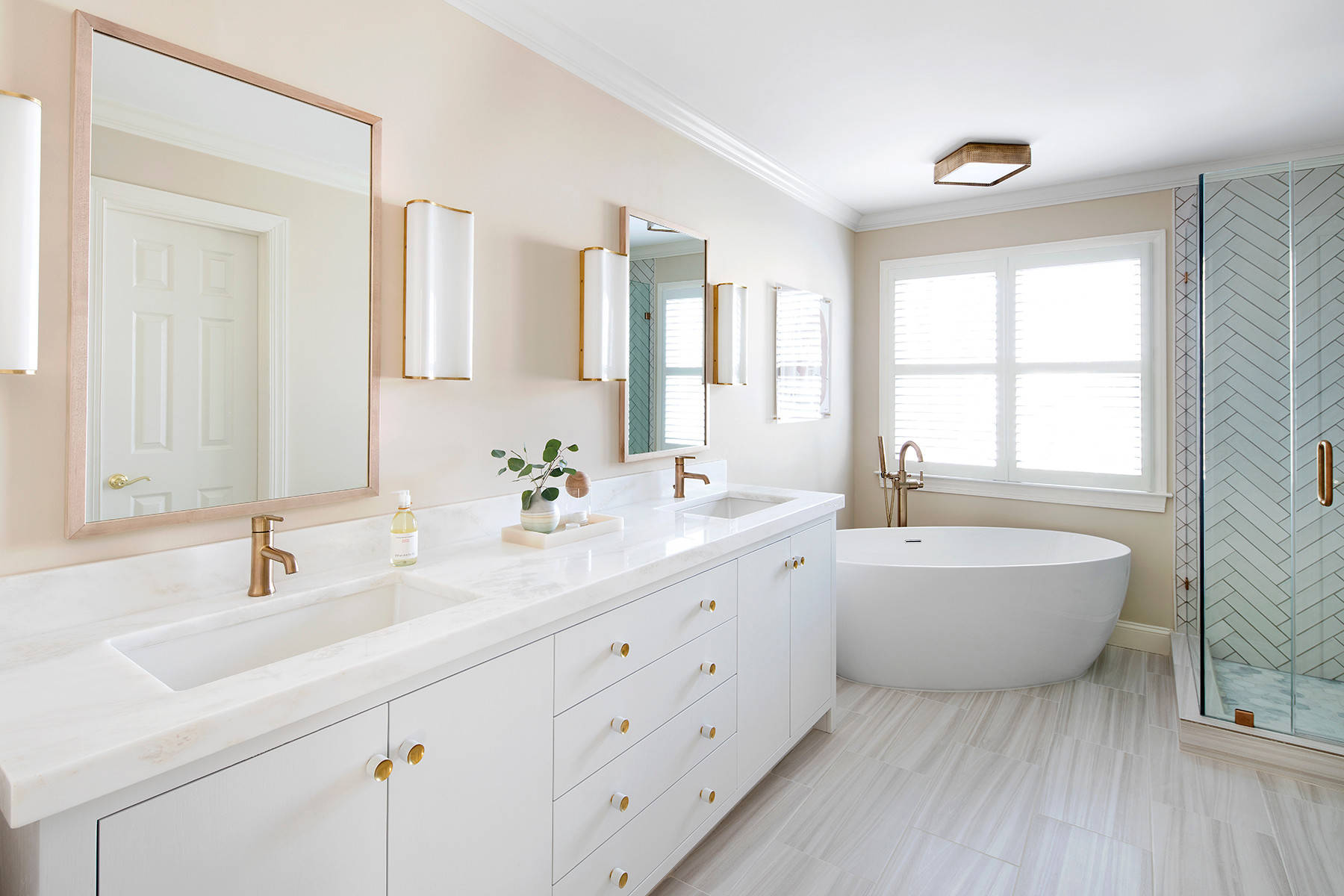 Bright and airy bathroom with freestanding tub and herringbone tile shower