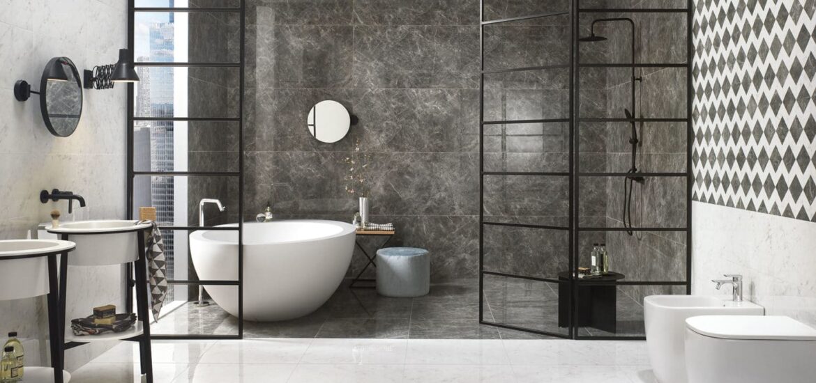 Modern bathroom featuring a freestanding oval tub, black-framed glass dividers, and dark marble accent wall