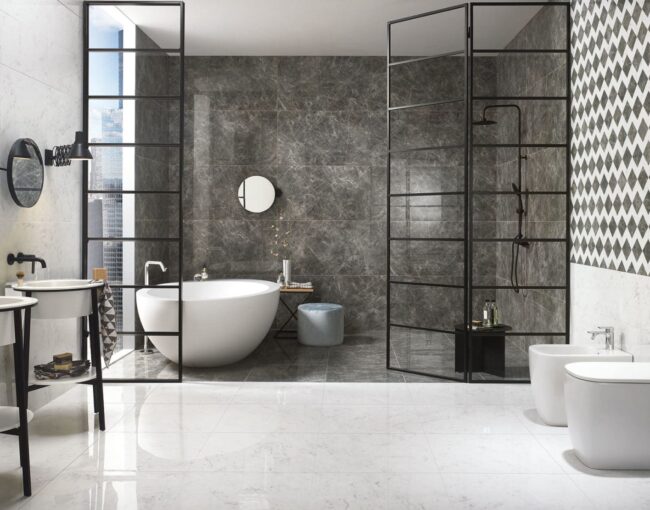 Modern bathroom featuring a freestanding oval tub, black-framed glass dividers, and dark marble accent wall