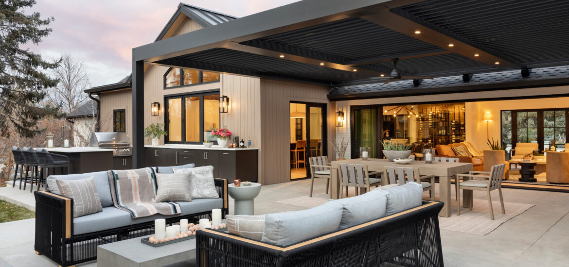 Stylish covered patio with modern outdoor kitchen, dining area, and lounge seating.