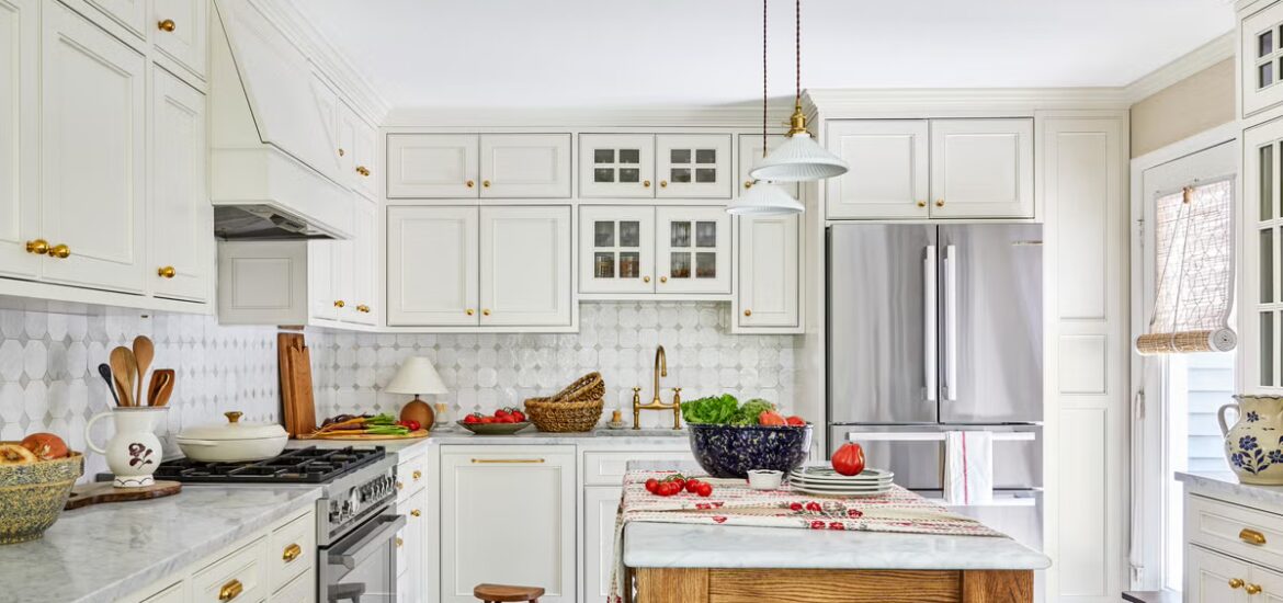 White kitchen with tile flooring, large island, and stainless steel appliances