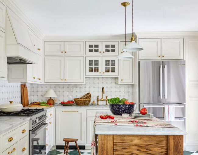 White kitchen with tile flooring, large island, and stainless steel appliances