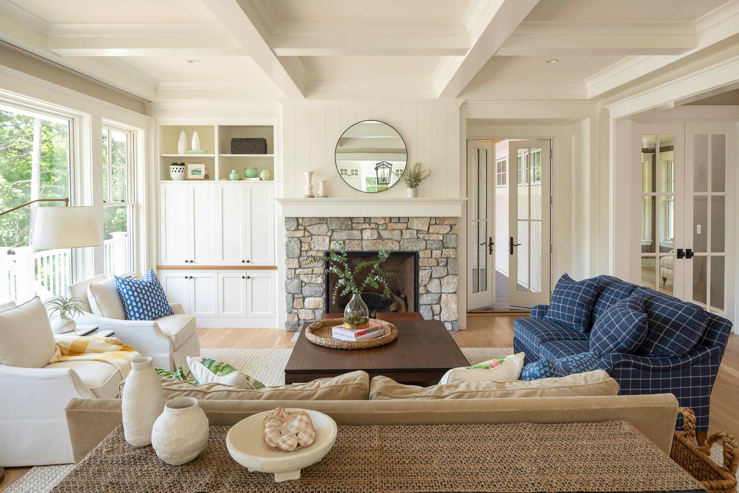 Cozy living room with stone fireplace and white built-in cabinets