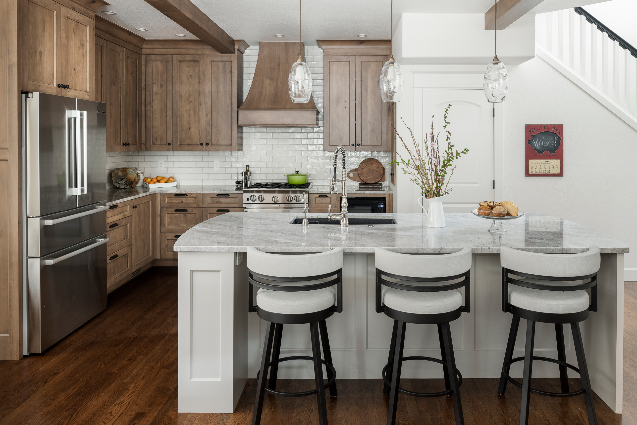 Modern farmhouse kitchen with wood cabinets and marble island