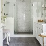 Elegant bathroom with glass-enclosed shower and hexagon tile accent wall.