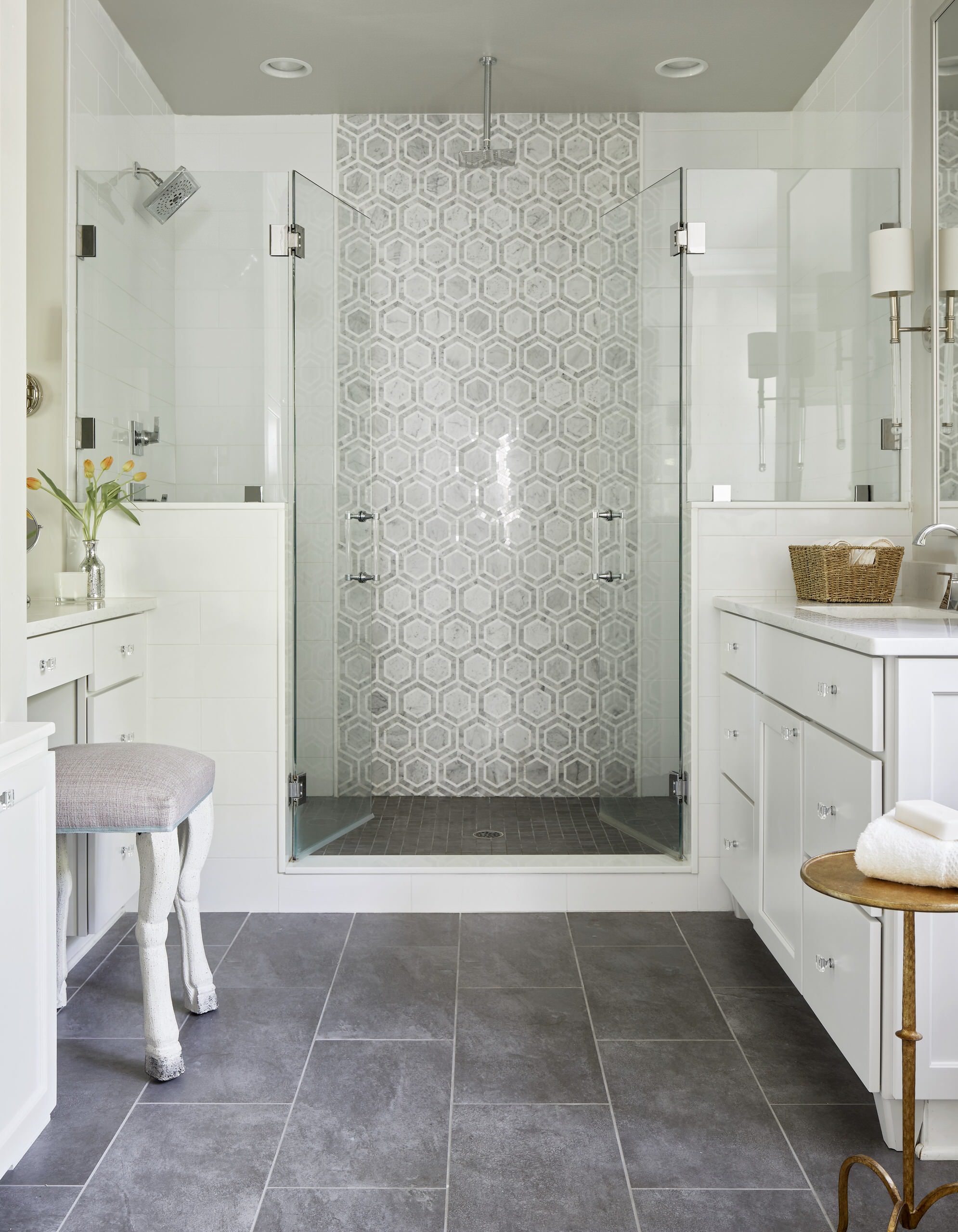 Elegant bathroom with glass-enclosed shower and hexagon tile accent wall.