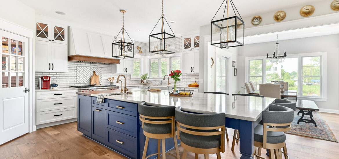 Bright kitchen with blue island cabinets, white cabinetry, and gold accents.