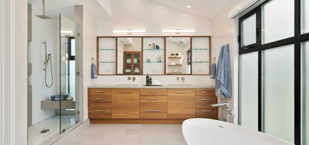 Modern bathroom with wooden vanity, freestanding tub, and walk-in glass shower