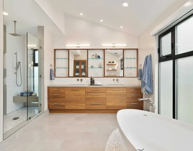 Modern bathroom with wooden vanity, freestanding tub, and walk-in glass shower