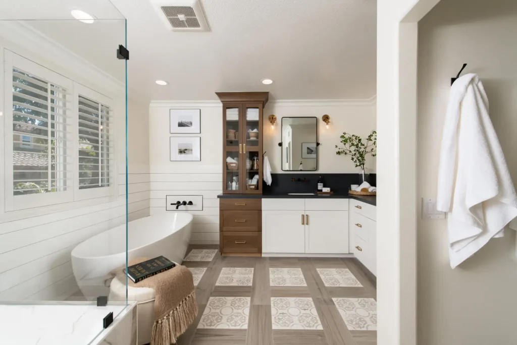 Elegant bathroom with patterned floor tiles, freestanding tub, and modern vanity