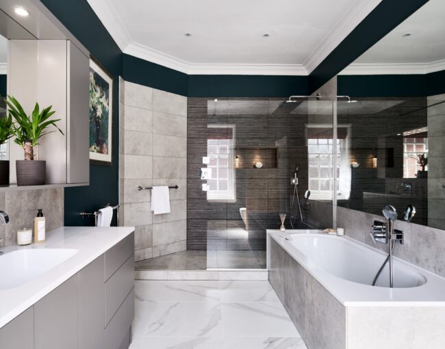 Contemporary bathroom with white and gray tones, walk-in shower, and built-in bathtub.