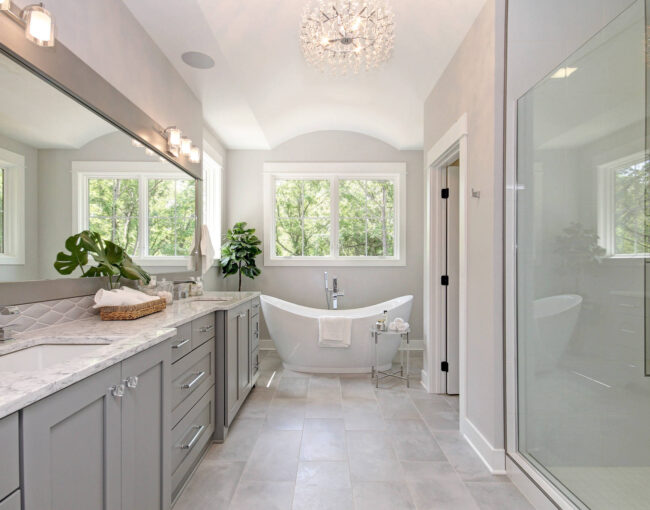 Elegant bathroom with freestanding tub, large vanity, and glass-enclosed shower.