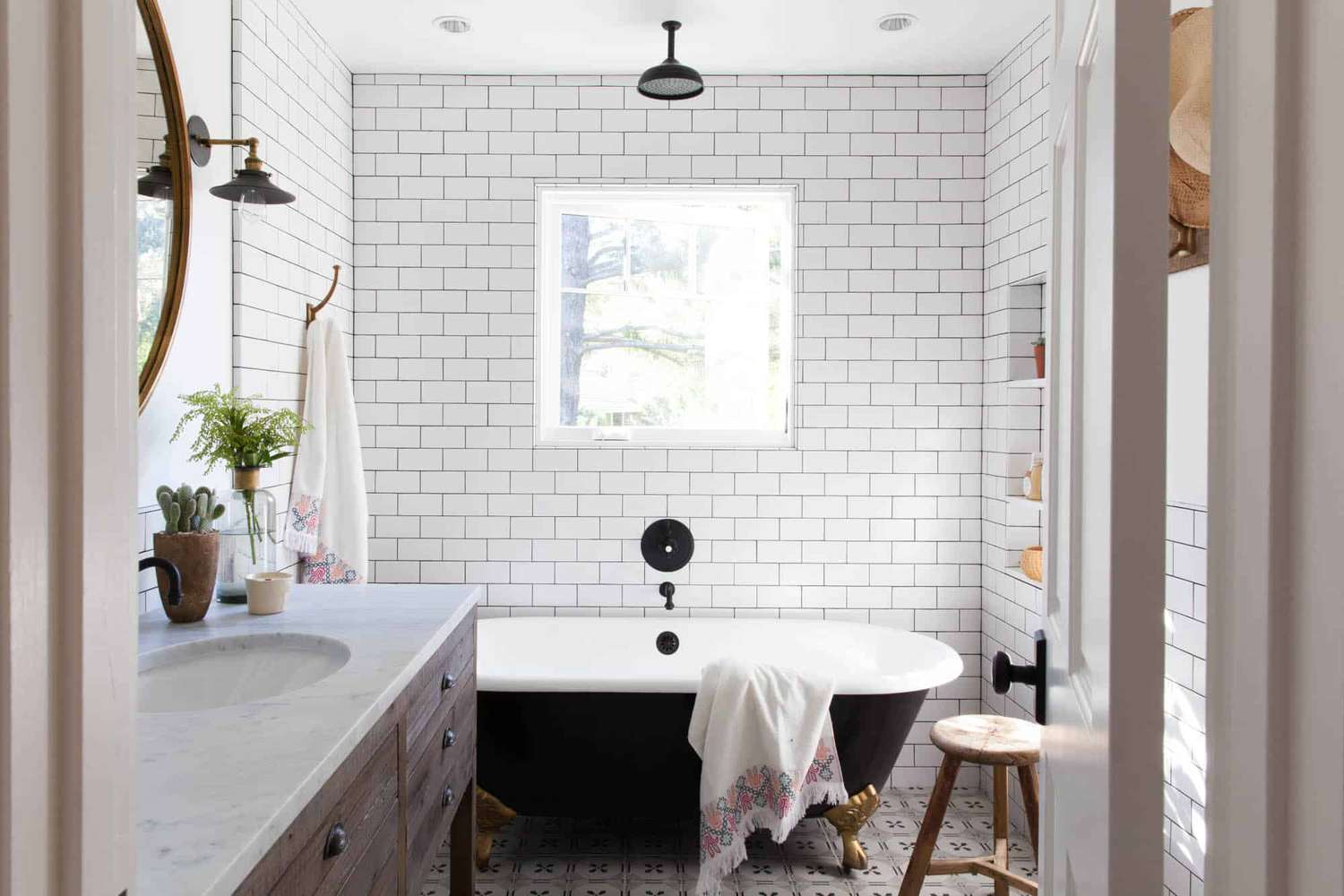 Charming farmhouse bathroom with clawfoot tub and white subway tile walls.