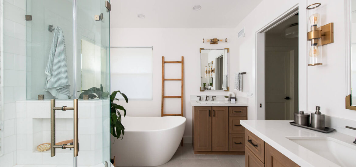 Modern bathroom with glass-enclosed shower, freestanding bathtub, and wooden vanities.