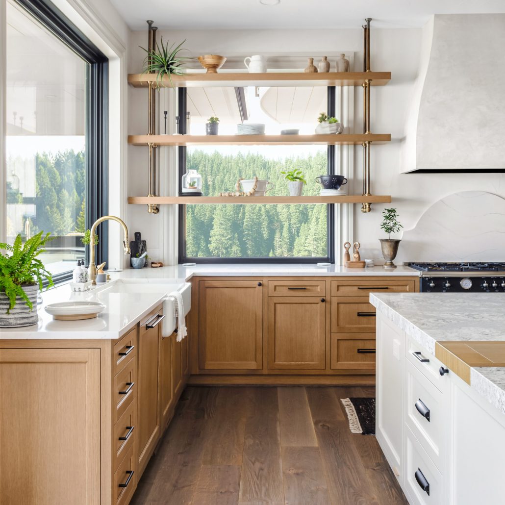 beautiful kitchen in new traditional style luxury home with island, pendant lights, and hardwood floors. kitchen in newly constructed luxury home